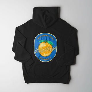 Drift House Fresh Squeezed Hoodie in Vintage Black — relaxed garment-dyed 9.4 oz fleece pullover with Florida orange front graphic, "Fresh Squeezed Threads" back print, drop shoulders, and kangaroo pocket