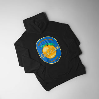 Drift House Fresh Squeezed Hoodie in Vintage Black — relaxed garment-dyed 9.4 oz fleece pullover with Florida orange front graphic, "Fresh Squeezed Threads" back print, drop shoulders, and kangaroo pocket