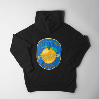 Drift House Fresh Squeezed Hoodie in Vintage Black — relaxed garment-dyed 9.4 oz fleece pullover with Florida orange front graphic, "Fresh Squeezed Threads" back print, drop shoulders, and kangaroo pocket