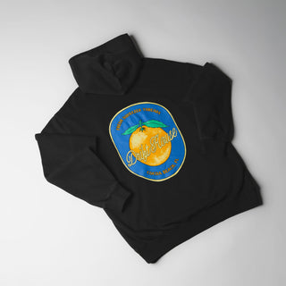 Drift House Fresh Squeezed Hoodie in Vintage Black — relaxed garment-dyed 9.4 oz fleece pullover with Florida orange front graphic, "Fresh Squeezed Threads" back print, drop shoulders, and kangaroo pocket