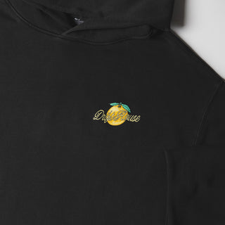 Drift House Fresh Squeezed Hoodie in Vintage Black — relaxed garment-dyed 9.4 oz fleece pullover with Florida orange front graphic, "Fresh Squeezed Threads" back print, drop shoulders, and kangaroo pocket