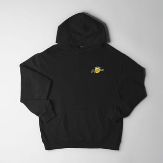 Drift House Fresh Squeezed Hoodie in Vintage Black — relaxed garment-dyed 9.4 oz fleece pullover with Florida orange front graphic, "Fresh Squeezed Threads" back print, drop shoulders, and kangaroo pocket