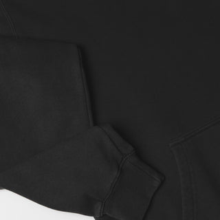 Drift House Fresh Squeezed Hoodie in Vintage Black — relaxed garment-dyed 9.4 oz fleece pullover with Florida orange front graphic, "Fresh Squeezed Threads" back print, drop shoulders, and kangaroo pocket