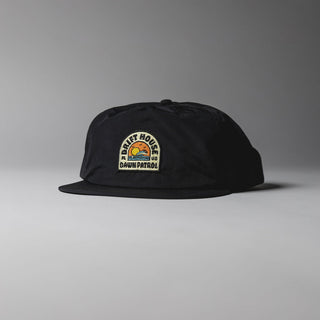 Black Drift House Dawn Patrol hat with sunrise wave patch and snapback.