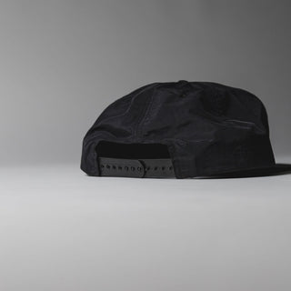 Black Drift House Dawn Patrol hat with sunrise wave patch and snapback.