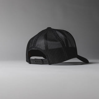 Black Drift House Hex trucker hat with mesh back and hex logo.