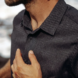 Close-up of black Roark Bless Up Shirt showing its lightweight, textured perforated fabric and collar.