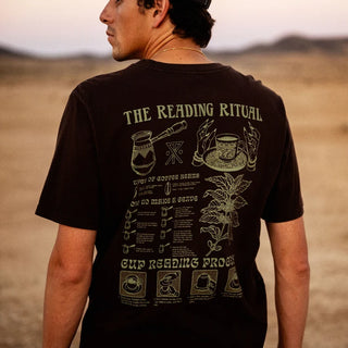 Roark Reading Ritual Premium Tee in Tobacco with a large cream-colored coffee-reading graphic featuring a coffee pot, cup, botanical illustration, and ritual instructions