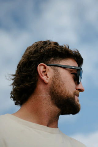 Otis Eyewear Offset Sport sunglasses in Matte Slate Tort with L.I.T Polar Grey mineral glass lenses, Italian-made Eco-Grilamid ultra-lightweight frame with increased pantoscopic tilt, subtle side blinders, integrated nose pads and temple tips, hand-painted finish, 52-20-127mm sizing