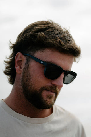 Otis Eyewear Offset Sport sunglasses in Matte Slate Tort with L.I.T Polar Grey mineral glass lenses, Italian-made Eco-Grilamid ultra-lightweight frame with increased pantoscopic tilt, subtle side blinders, integrated nose pads and temple tips, hand-painted finish, 52-20-127mm sizing