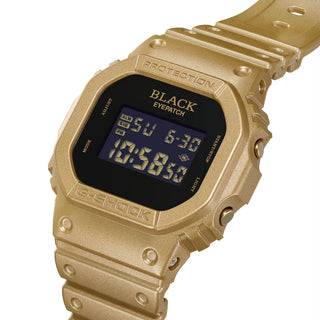 G-SHOCK DW5600BEP-9 BlackEyePatch watch with a gold-tone square case and band, black face, digital display, and BlackEyePatch branding