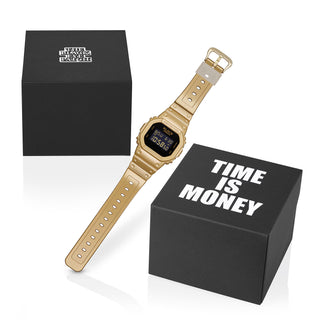 G-SHOCK DW5600BEP-9 BlackEyePatch watch with a gold-tone square case and band, black face, digital display, and BlackEyePatch branding