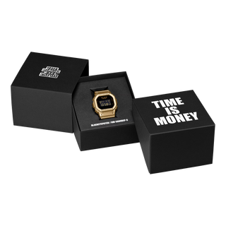G-SHOCK DW5600BEP-9 BlackEyePatch watch with a gold-tone square case and band, black face, digital display, and BlackEyePatch branding