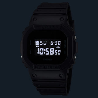 Black Casio digital watch on a black background
