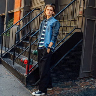 Person standing on a set of stairs in an urban setting