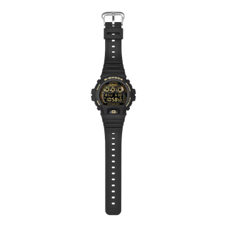 "G-Shock DW6900CF-1 Bold Camo Gold Watch — black bezel and band, camo dial with gold vapor deposition accents, classic 6900 silhouette"