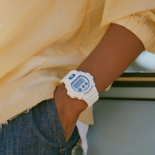 G-SHOCK DW-6900HDS-7 in white with glowing blue face and marine-inspired details.