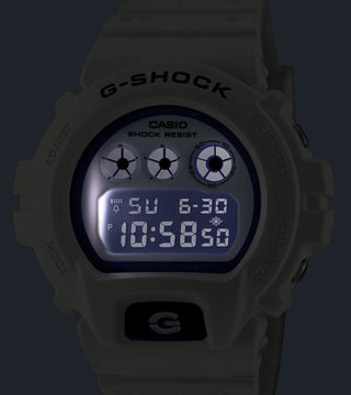 G-SHOCK DW-6900HDS-7 in white with glowing blue face and marine-inspired details.