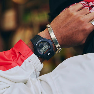 G-SHOCK DW6900RL-1 watch with iconic red, blue, and yellow color scheme, shock resistant bio-based resin construction, 200m water resistance, LED backlight, and multi-function features