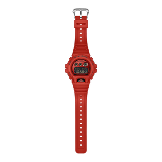 Red G-Shock DW6900RRB-4 digital watch with matching red bezel and band, black accents, and inverted LCD display.