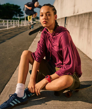 Red G-Shock DW6900RRB-4 digital watch with matching red bezel and band, black accents, and inverted LCD display.