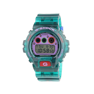 “Jae Tips G-SHOCK watch with translucent teal case and strap, lavender face, multicolor dial accents, flower graphics, and a red front button.”
