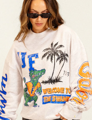 Duvin x Florida Gators Crew Fleece in Grey with UF lettering, Albert the Gator, palm trees, “Welcome to the Swamp” graphics, and sleeve lettering.