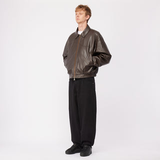 Dime brown quilted jacket with wavy debossed pattern and oversized logo patch.