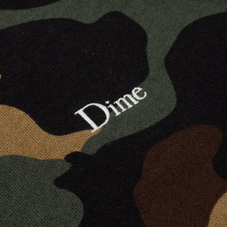 Front view of Dime Classic Logo Crewneck in Dark Camo with green, brown, tan, and black camouflage, a small light-colored embroidered chest logo, and black collar, cuffs, and hem