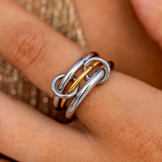 Mixed-metal statement ring with bold sculpted design.