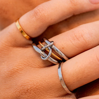 Mixed-metal statement ring with bold sculpted design.