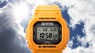 Yellow Casio G-Shock digital watch with a blue sky and clouds in the background