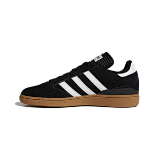 Black Adidas sneaker with white stripes on a white background