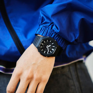 Front view of the black G-SHOCK GA2100-1A watch with an octagonal bezel, gray hands and indices, and an analog-digital dial