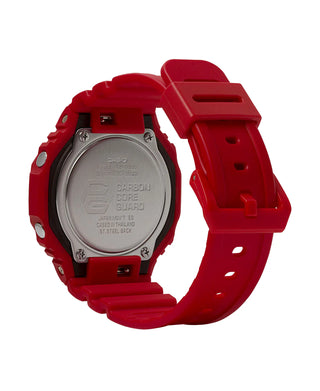 Red Casio watch with a clear back cover on a white background