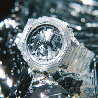 Clear Casio watch with black face on a reflective water surface