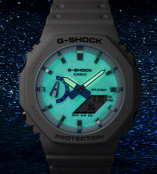 G-Shock Casio watch glowing in the dark with a blue background