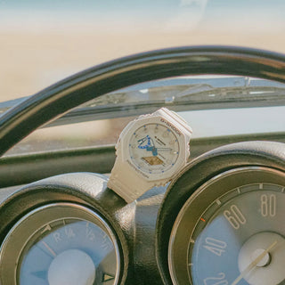Watch on a car dashboard with a blurred background