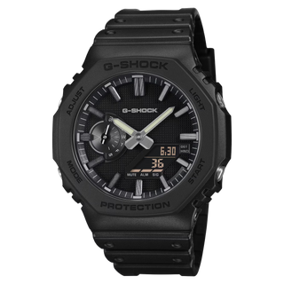 G-SHOCK GA-2100LXB-1A Watch in Black/Gold — CasiOak silhouette with carbon core guard structure, black IP stainless steel bezel, gold-tone accents, analog-digital display, 200M water resistant