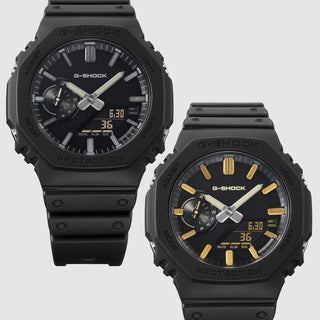 G-SHOCK GA-2100LXB-1A Watch in Black/Gold — CasiOak silhouette with carbon core guard structure, black IP stainless steel bezel, gold-tone accents, analog-digital display, 200M water resistant