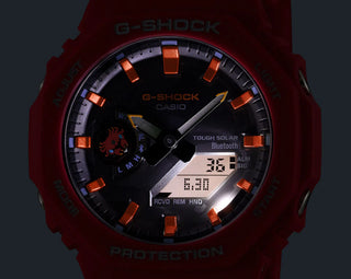 Black and red-orange G-Shock GAB2100DF-4A watch with crab-inspired accents, octagonal case, and Galápagos island dial graphic.
