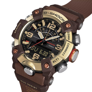 Front view of the G-SHOCK GGB100XMH-5A Mudmaster with a gold-tone bezel, dark brown case and band, black analog-digital dial, and red second hand