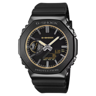 G-SHOCK GM2100LXB-1A9 Watch in Brown/Gold — CasiOak silhouette with stainless steel case, carbon core guard structure, gold IP bezel with warm-tone accents, analog-digital display, 200M water resistant