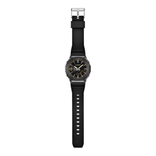 G-SHOCK GM2100LXB-1A9 Watch in Brown/Gold — CasiOak silhouette with stainless steel case, carbon core guard structure, gold IP bezel with warm-tone accents, analog-digital display, 200M water resistant