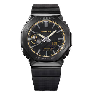 G-SHOCK GM2100LXB-1A9 Watch in Brown/Gold — CasiOak silhouette with stainless steel case, carbon core guard structure, gold IP bezel with warm-tone accents, analog-digital display, 200M water resistant
