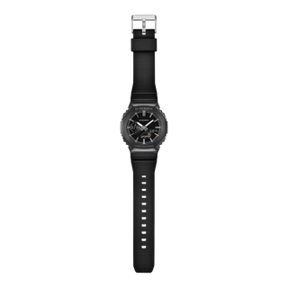 G-SHOCK GM-2100LXB-1A Watch in Black/Gold — CasiOak silhouette with stainless steel case, carbon core guard structure, black IP bezel with gold-tone accents, analog-digital display, 200M water resistant