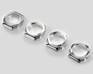 Set of five silver watch cases on a light gray background