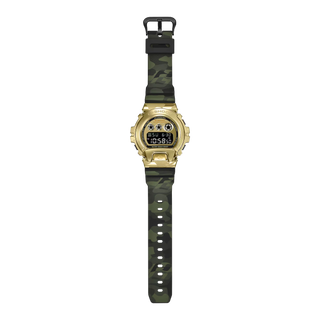 "G-Shock GM6900CMG-3 Bold Camo Gold Watch — gold-colored metal bezel, gold dial, camo printed band with hidden G-mark, classic 6900 silhouette"