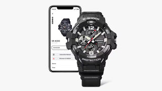 Front view of the G-SHOCK GRB300H-5A Gravitymaster with a dark brown case and band, gold-tone bezel accents, black analog dial, and red second hand