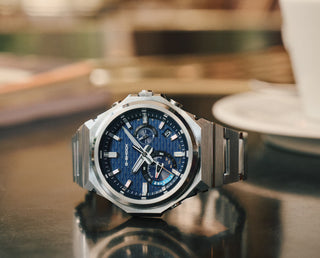 G-Shock GSTB1000D-2A watch with blue dial, stainless steel case and band, and minimalist metal bezel design.